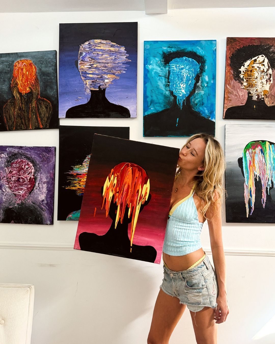 Stevie Alger with one of her faceless portraits