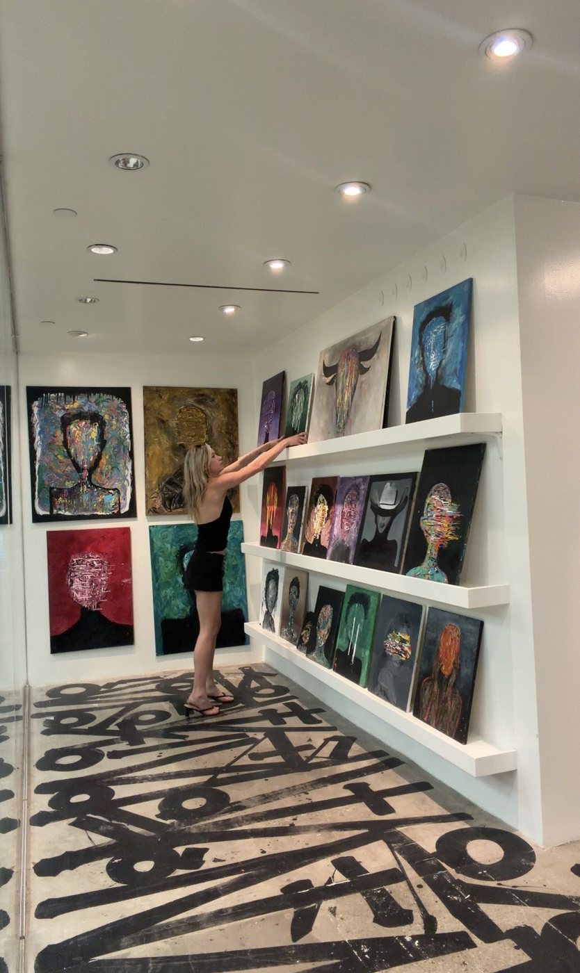 Stevie Alger hanging work at BaileyWick Gallery